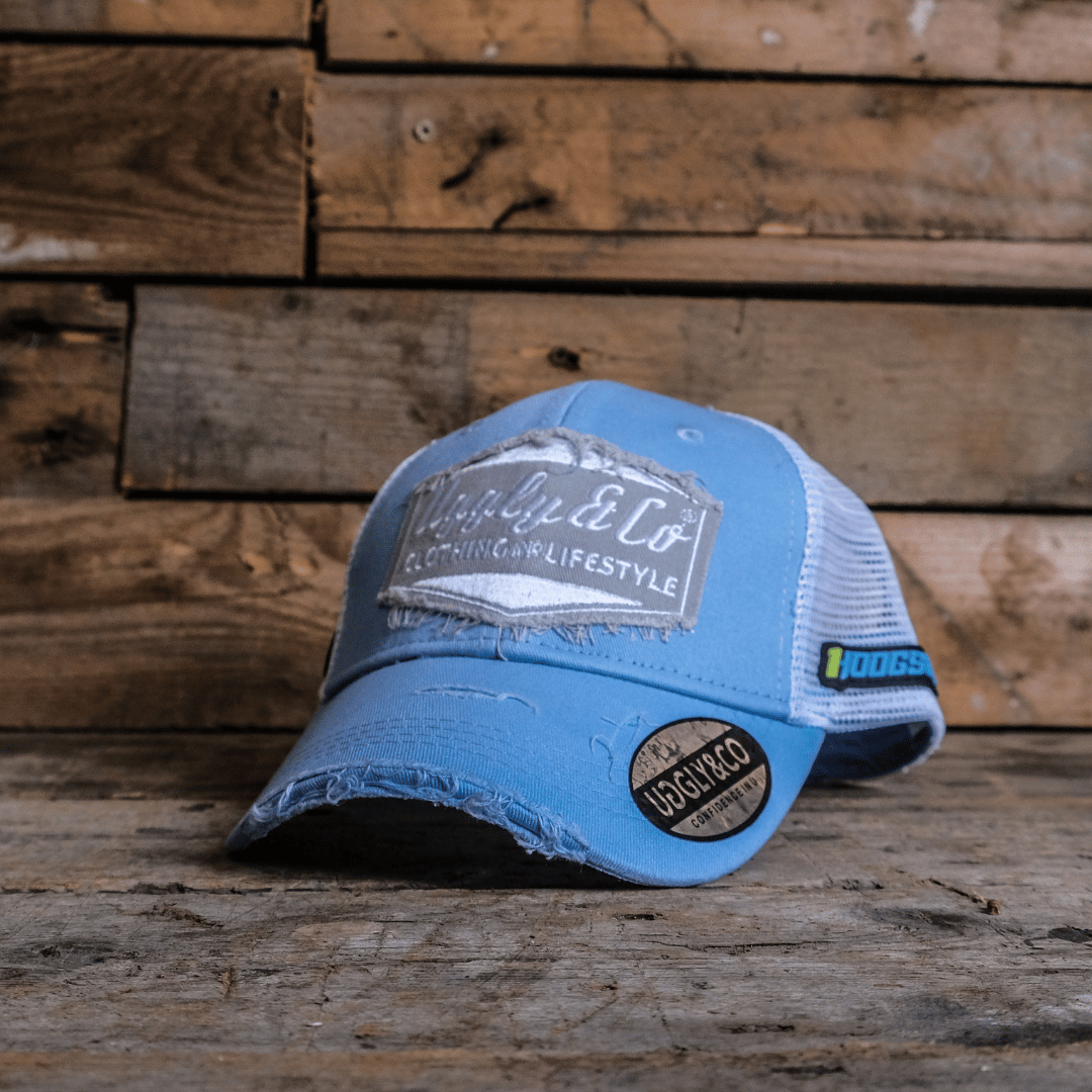 Blue trucker hat with a patch on a wooden surface