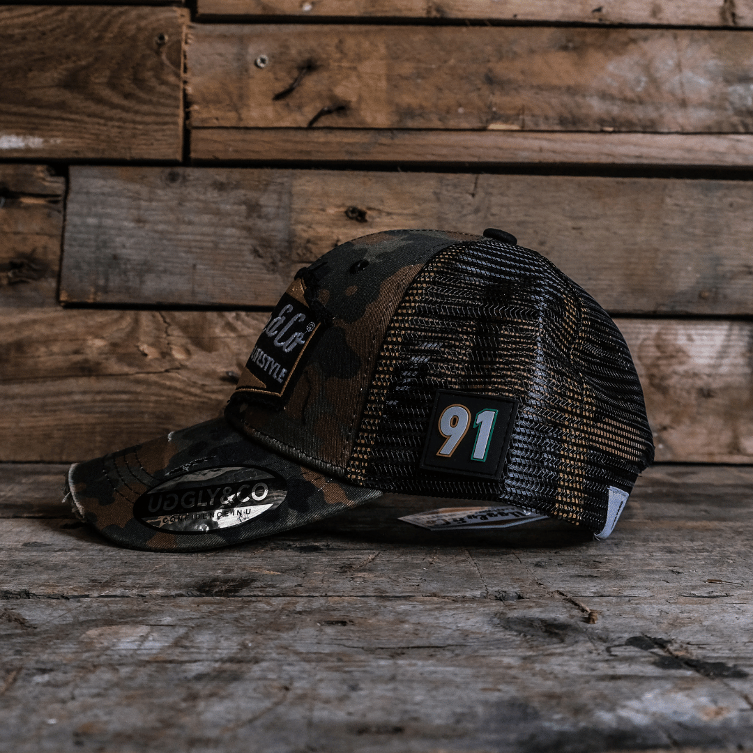 Black and brown trucker hat side view with number 91 on a wooden surface