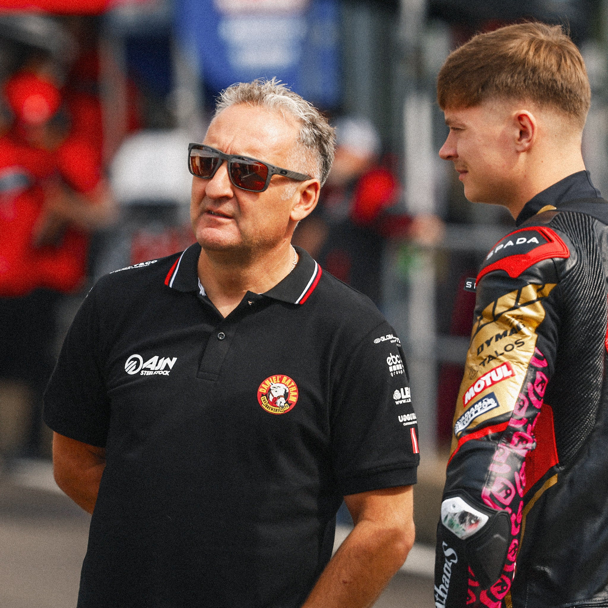 Storm stacey stood with mechanic wearing uggly and co team gear in pit lane at bsb