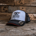A black and white baseball cap with the Carl Cox Motorsport logo on the front.