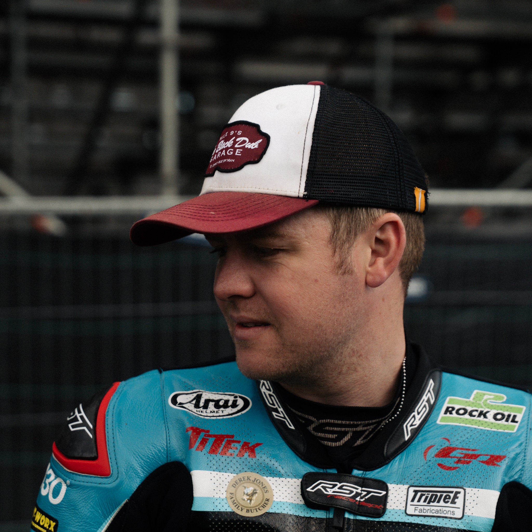 Dan Ingham in black dub hat by race stands side profile