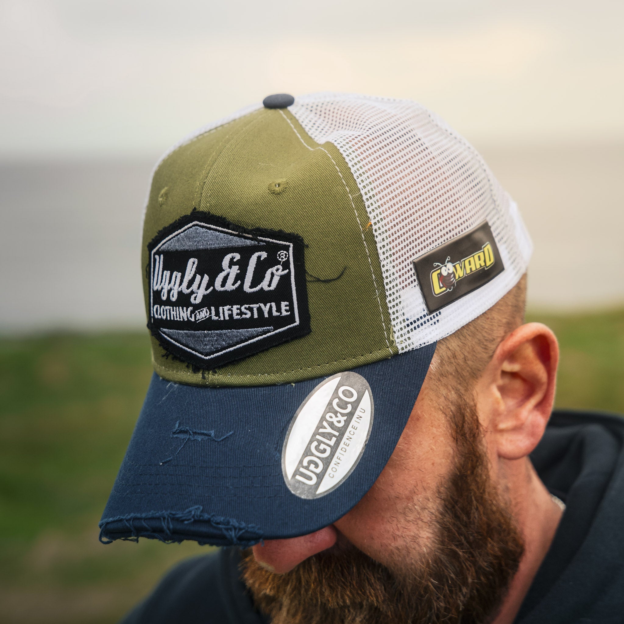 Jamie Coward in green and navy trucker hat