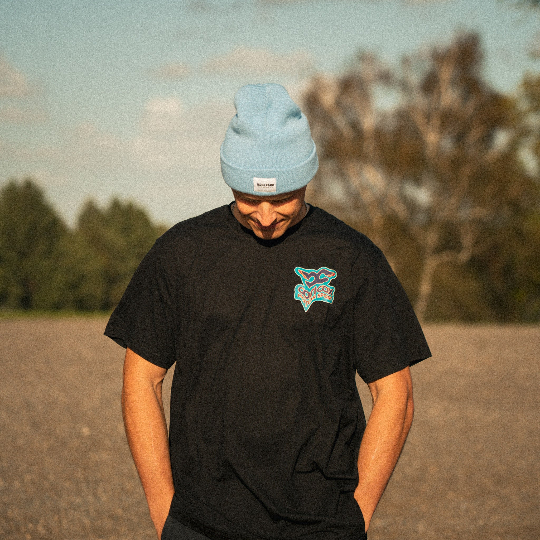 bsb rider Simon Reid wearing carl cox motorsport t shirt and blue beanie in lifestyle setting 