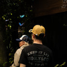 Sylvain Guintoli and wife in the butchers tap trucker hat stood in forest with butterflies