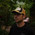 Sylvain Guintoli in the butchers tap trucker hat stood in forest