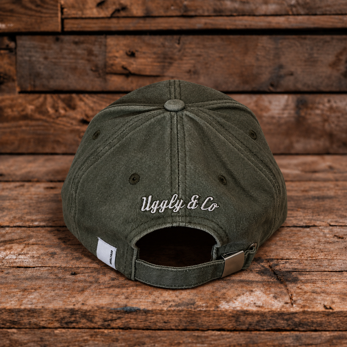 product photo showing the back logo on green baseball cap on a wood background