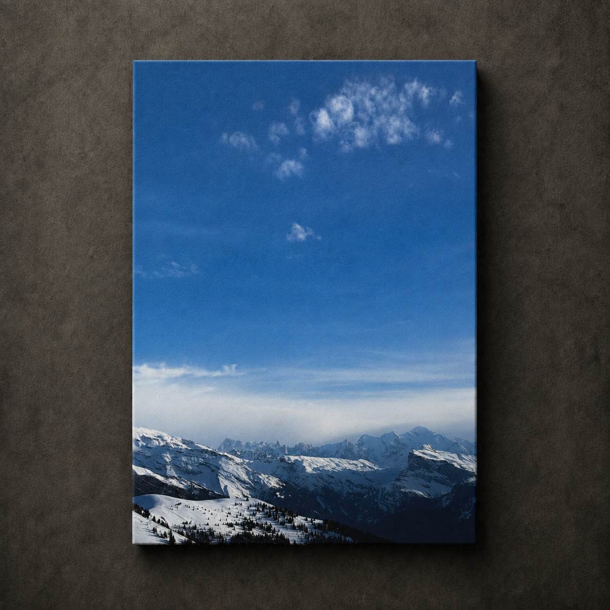Snow covered mountain range beneath a wide blue sky, shown as scenic canvas wall art.