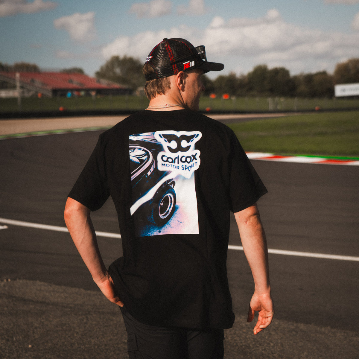Rear view of the Carl Cox Trucker Hat by Uggly & Co, featuring breathable mesh panels and an adjustable snapback fastening.