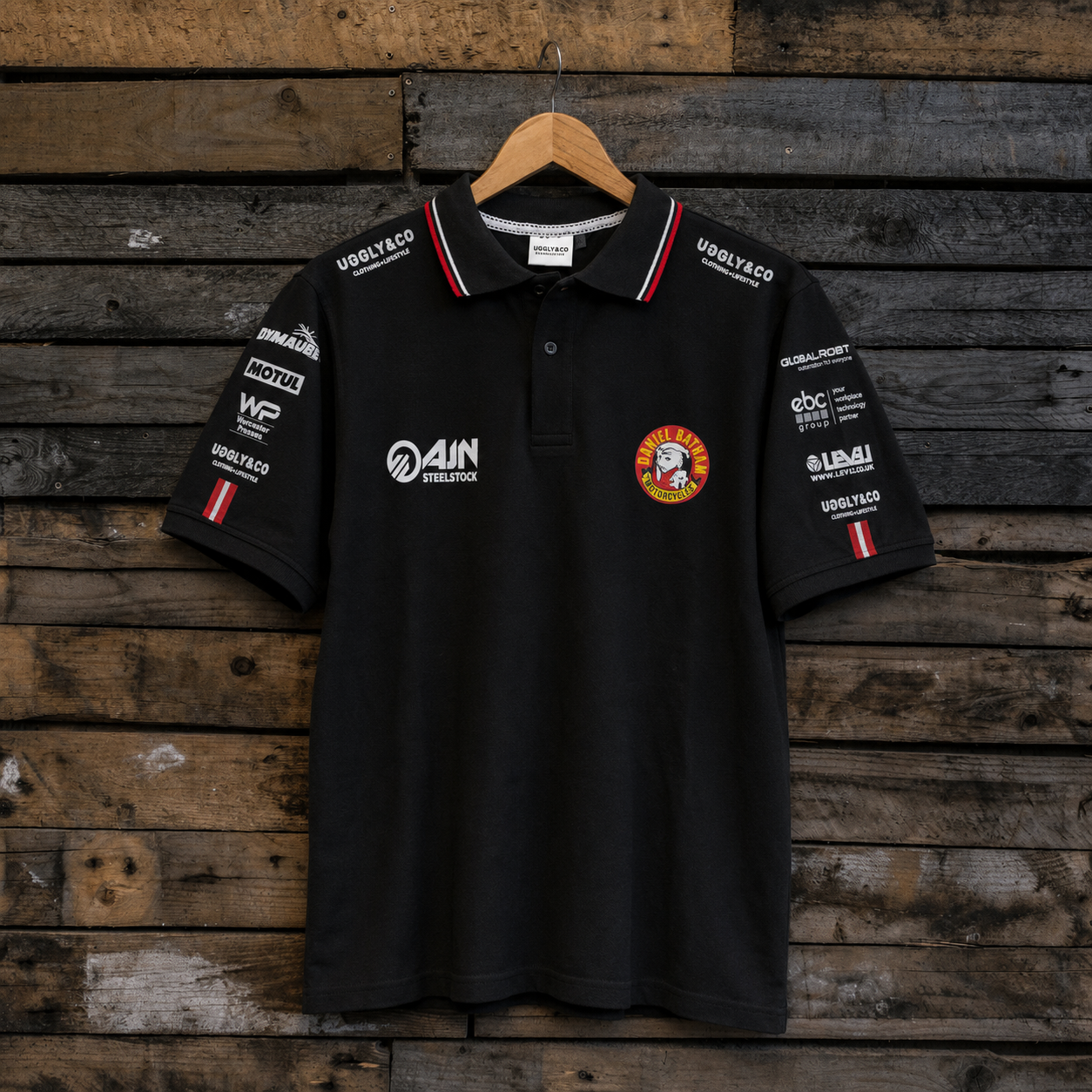 Front view of the Bathams Racing x AJN Steelstock Road Racing Polo featuring team sponsor logos and racing branding.