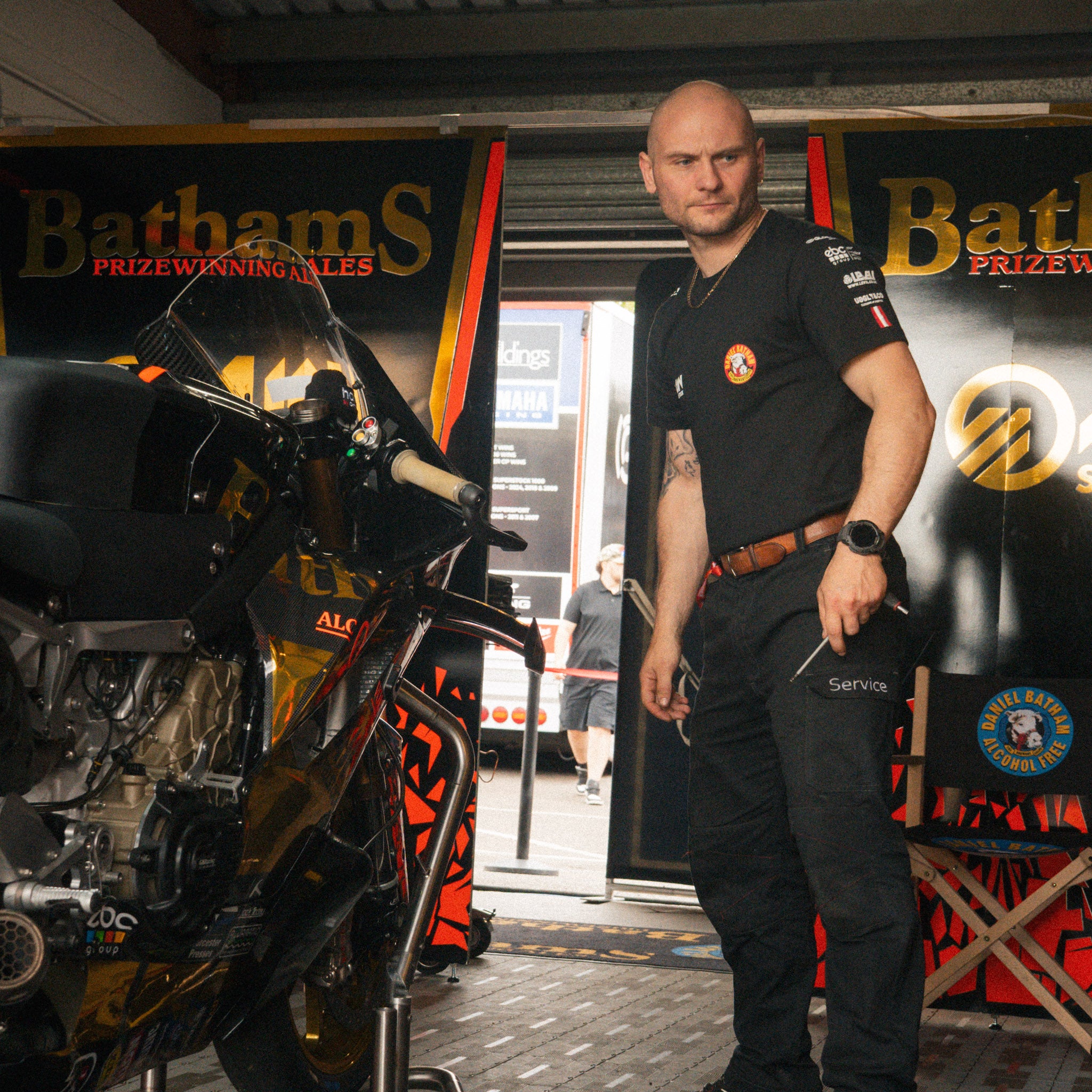 Bathams Racing team mechanics wearing the AJN Steelstock Road Racing T-Shirt in the race garage