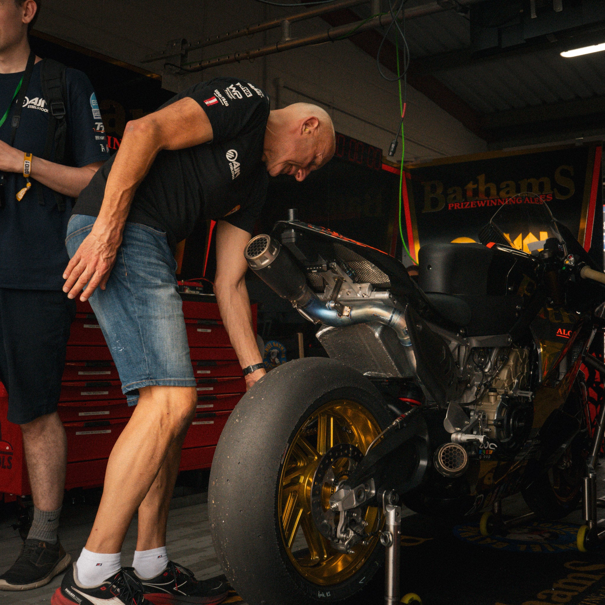 Behind the scenes with Bathams Racing mechanics wearing the AJN Steelstock Road Racing T-Shirt