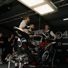 Bimota FS-3 team wearing British Superbikes Polo Shirts inside the race garage.