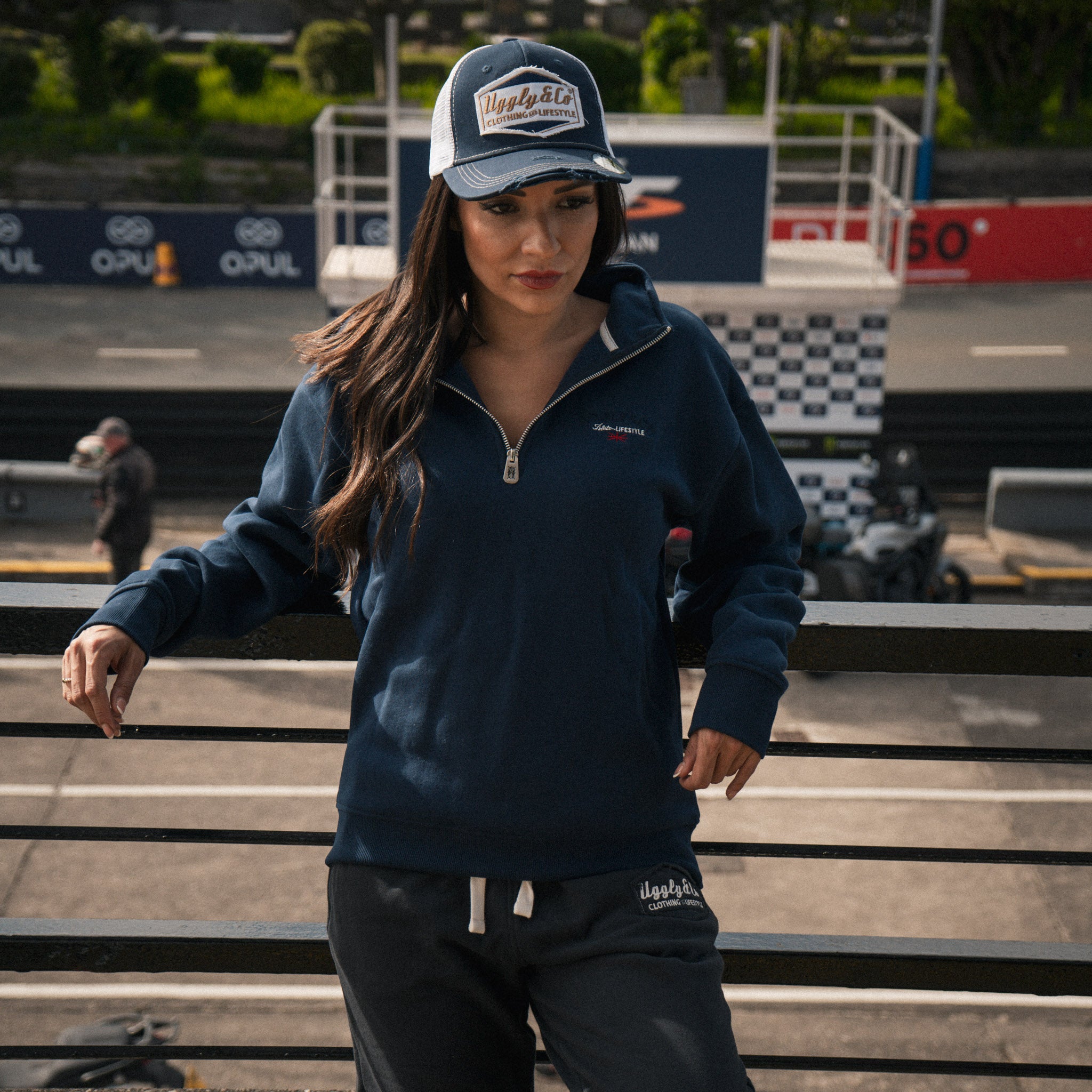 Female model wearing Black Diamond Heavyweight Joggers in a motorcycle race paddock
