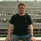 Lifestyle photo of Steve Day in the black Uggly&Co ‘The Map’ tee at the track