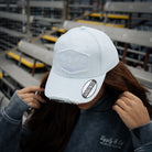 close up shot of a girl in a baby blue hat and blue acid wash hoodie