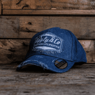 Blue denim Baseball Cap with Uggly&Co branding on a wooden background