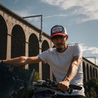 Motorcycle rider wearing the Blue and Red Diamond Trucker Hat