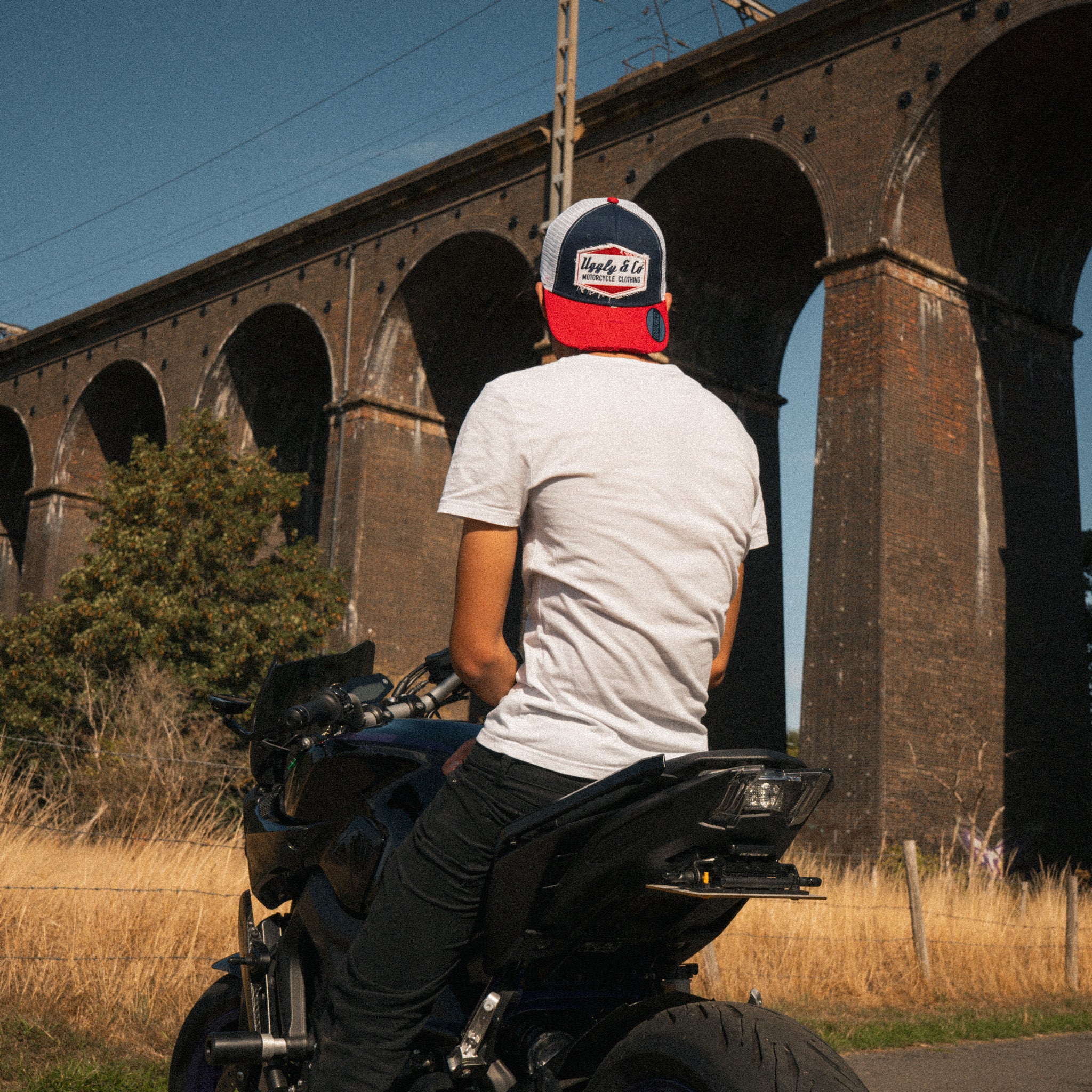 Lifestyle photo of a rider wearing the Blue and Red Diamond Trucker Hat