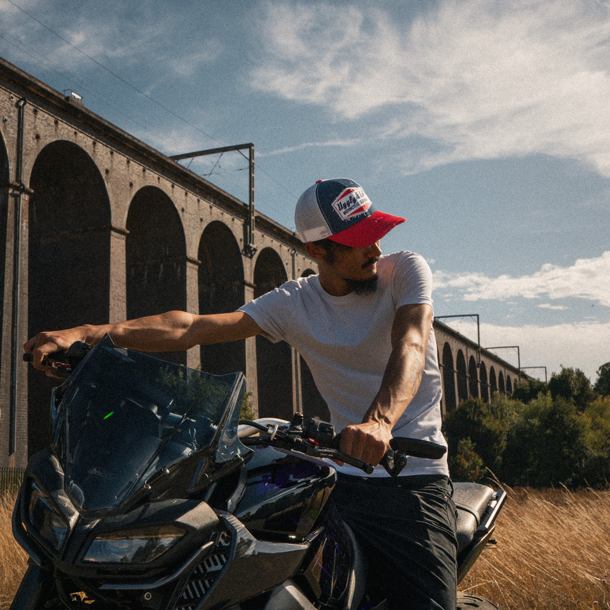 Lifestyle photo of a rider wearing the Blue and Red Diamond Trucker Hat
