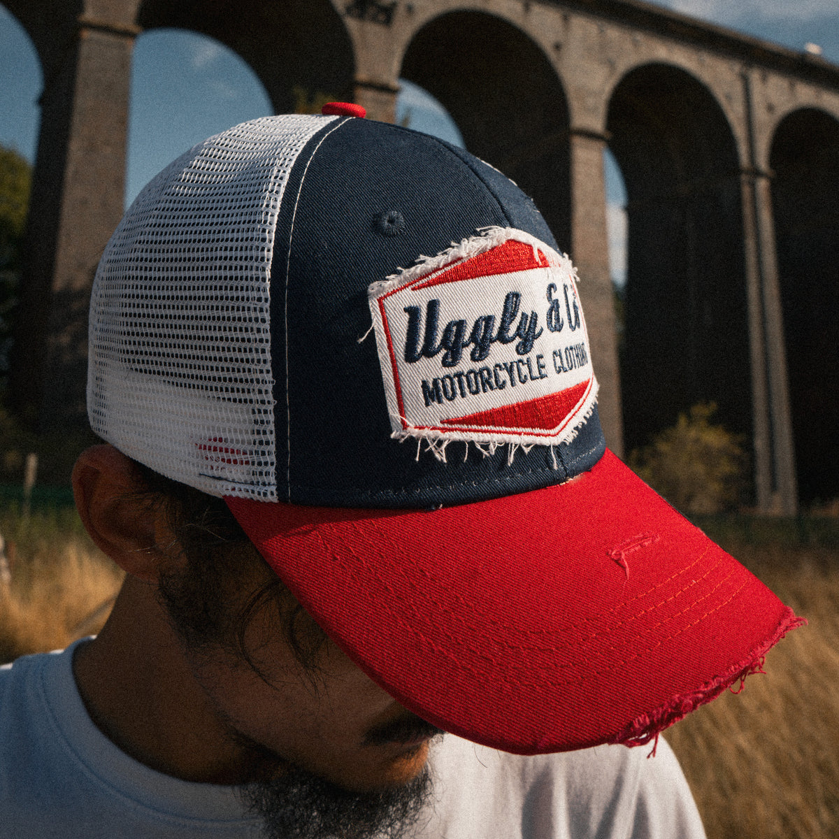 Close up of a motorcycle rider wearing the Blue and Red Diamond Trucker Hat