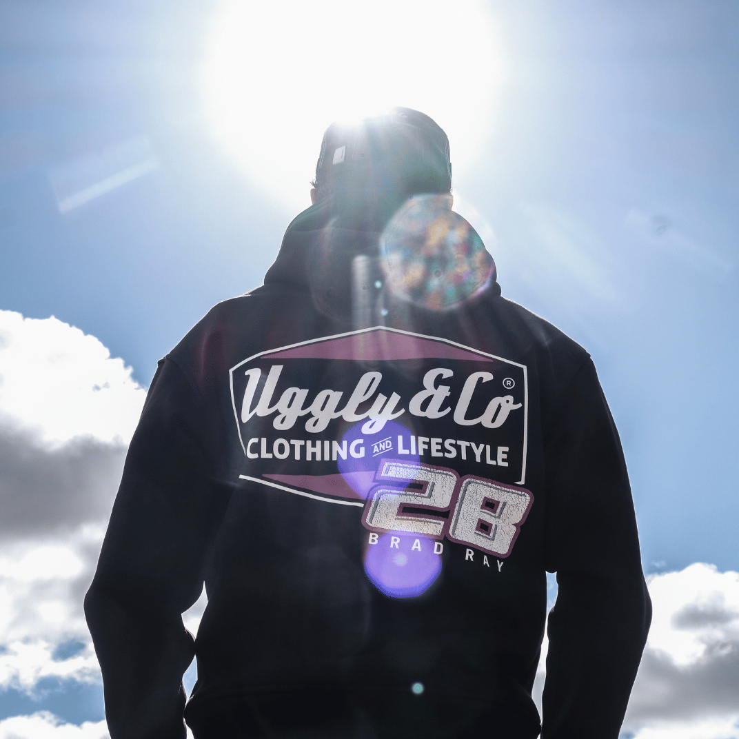 Rear view of a model wearing a black hoodie with a Uggly&Co and Bradley Ray inspired Brad Ray 28 logo