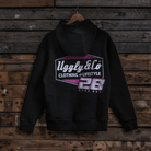 Black hoodie with a Uggly&Co and Bradley Ray 28 brand logo on a wooden background