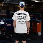 Bradley Ray wearing White 'Take the Risk' T-Shirt in a McAMS Yamaha motorcycle garage setting