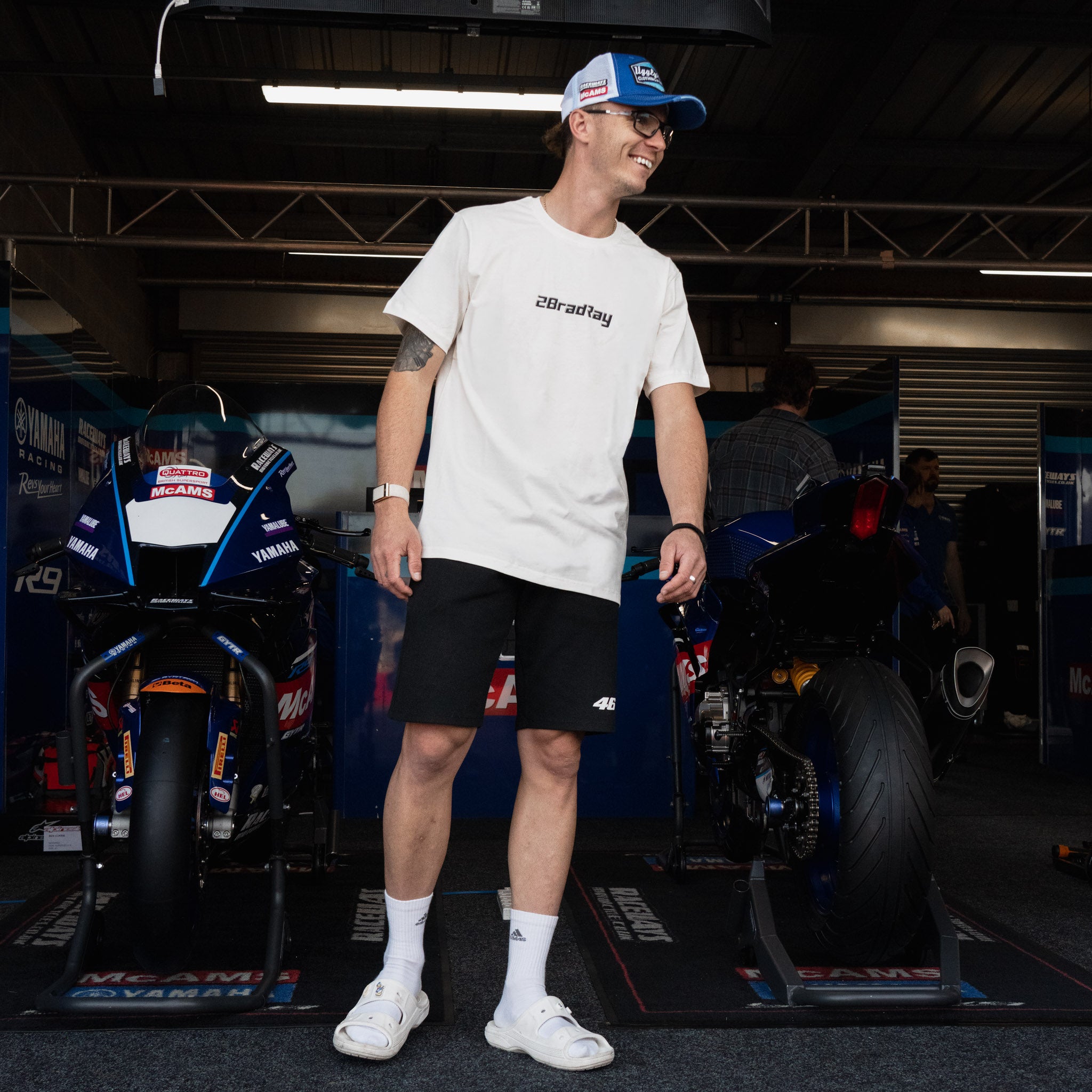 White Bradley Ray 'Take the Risk' T-Shirt in a motorcycle garage
