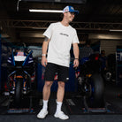 White Bradley Ray 'Take the Risk' T-Shirt in a motorcycle garage