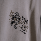 Close up view of the chest logo on a Tom Kerridge's Butchers Tap and Grill white t-shirt with black graphics and text
