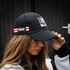 girl wearing carl cox motorsport jacket and cap