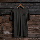 Front view of a Carl Cox Motorsport BPM RPM green t-shirt on a wooden background