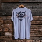 Rear view of a Carl Cox Motorsport drag racing santa pod graphic white t-shirt on a wooden background