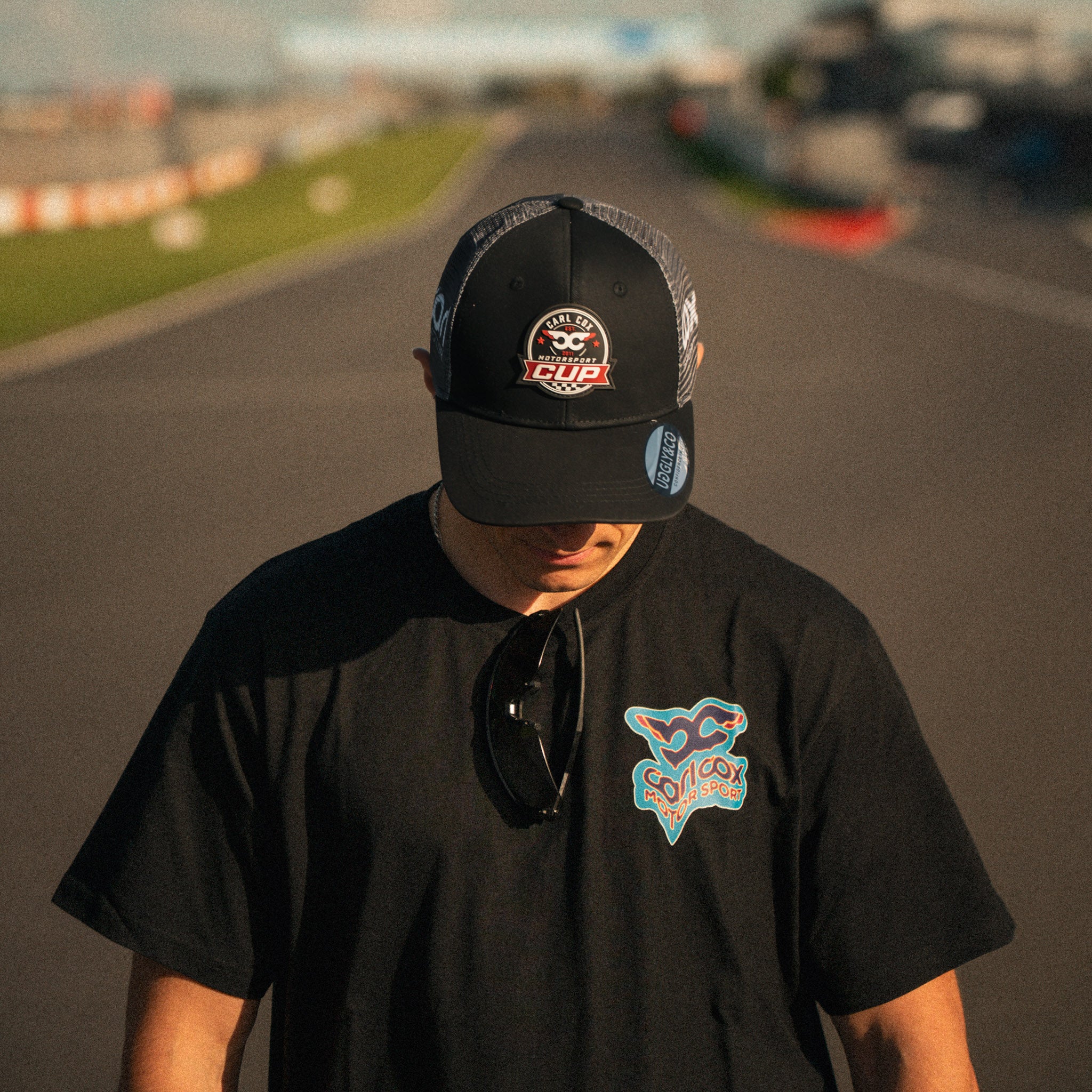 Front view of the Carl Cox Motorsport Cup Cap by Uggly & Co, featuring motorcycle racing inspired branding and classic motorsport headwear styling.