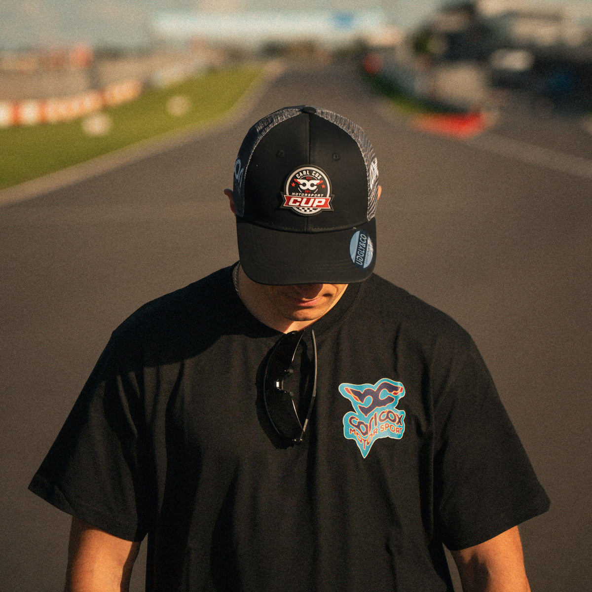 Front view of the Carl Cox Motorsport Cup Cap by Uggly & Co, featuring motorcycle racing inspired branding and classic motorsport headwear styling.