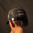 Close-up of the Carl Cox Motorsport Cup Cap branding, showcasing the racing inspired logo and detailing on this motorcycle lifestyle accessory.