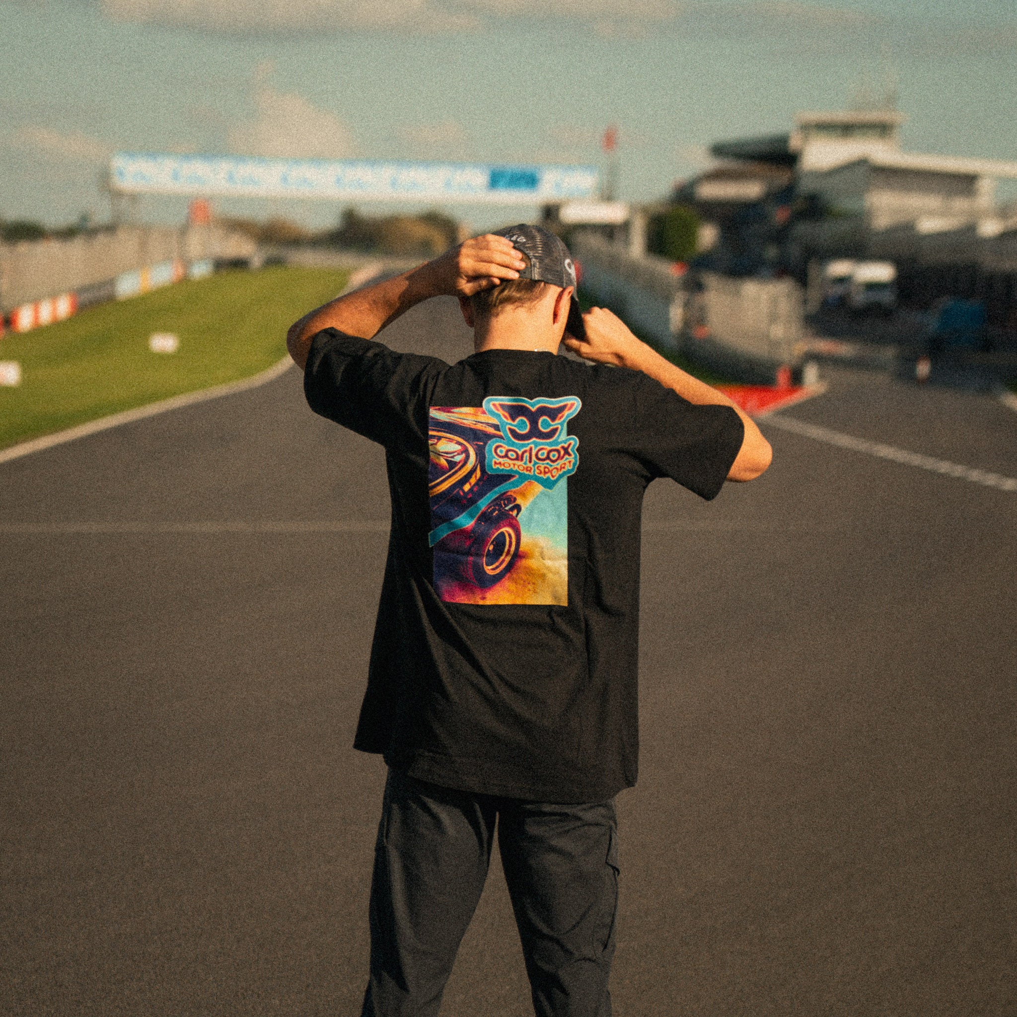 Carl Cox Motorsport Neon Street Drive T-Shirt photographed trackside at Donington Park, showcasing motorcycle racing inspired clothing from Uggly & Co.