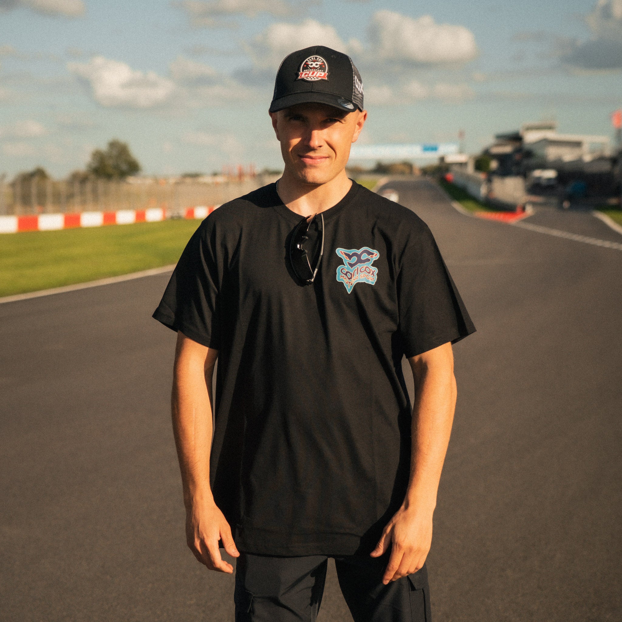 Motorcycle racer Simon Reid wearing the Carl Cox Motorsport Neon Street Drive T-Shirt by Uggly & Co at Donington Park during a British Superbike racing weekend.