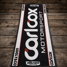 Carl Cox Motorsport Supported Rider garage mat with bold black, white and red Uggly&Co branding