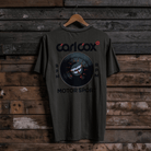 Rear view of a Carl Cox Motorsport BPM RPM green t-shirt on a wooden background