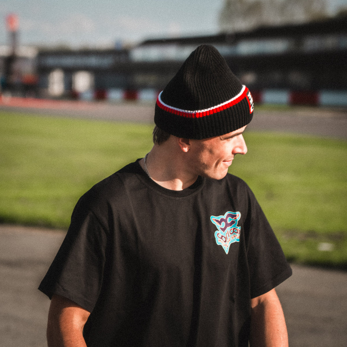 Side profile of the Carl Cox North West 200 Beanie, showcasing its classic knitted design and motorsport inspired styling.