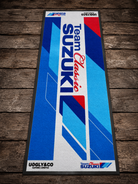 Team Suzuki mat with blue and red design on a wooden surface