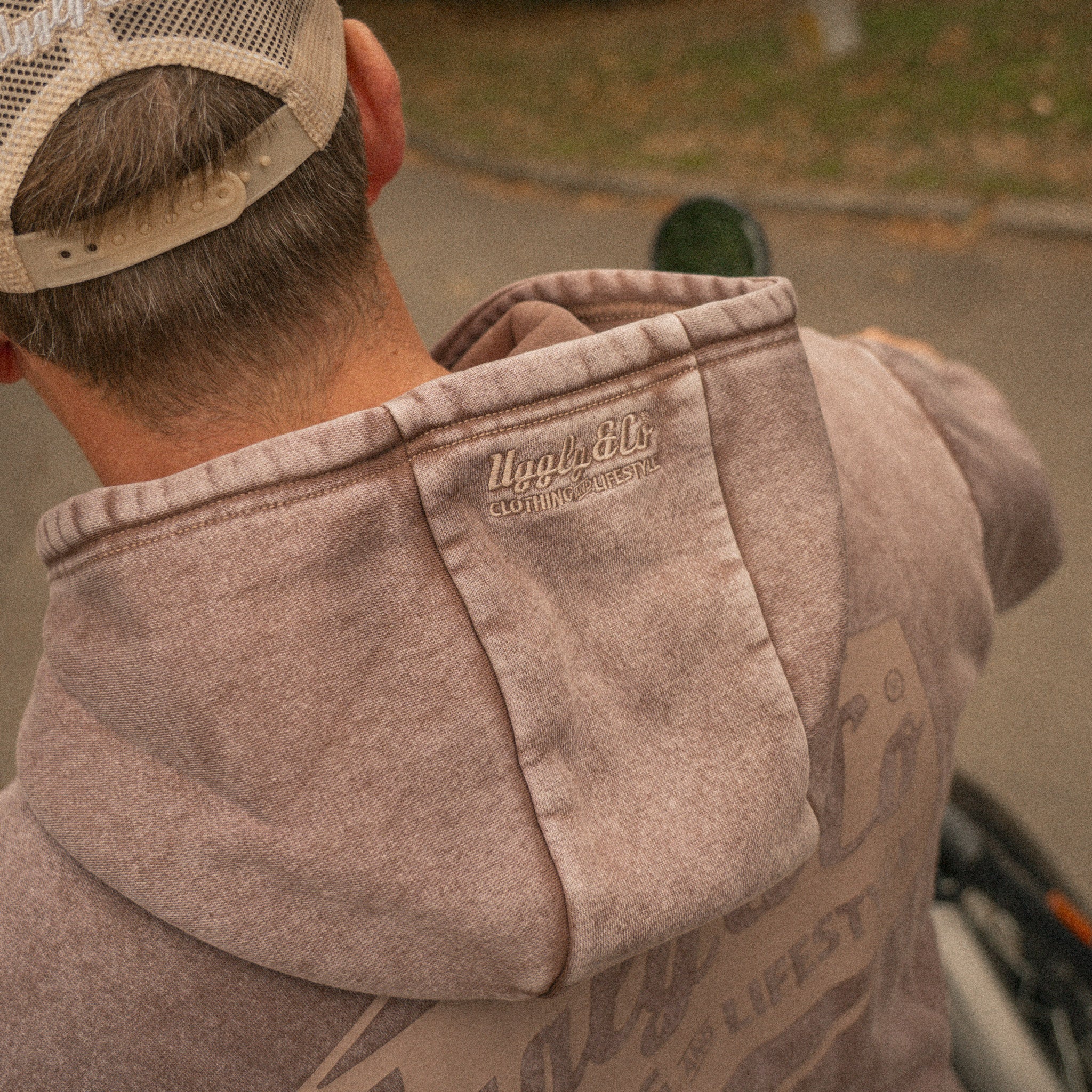 Close up of the Acid Wash Hoodie fabric and branding on hood