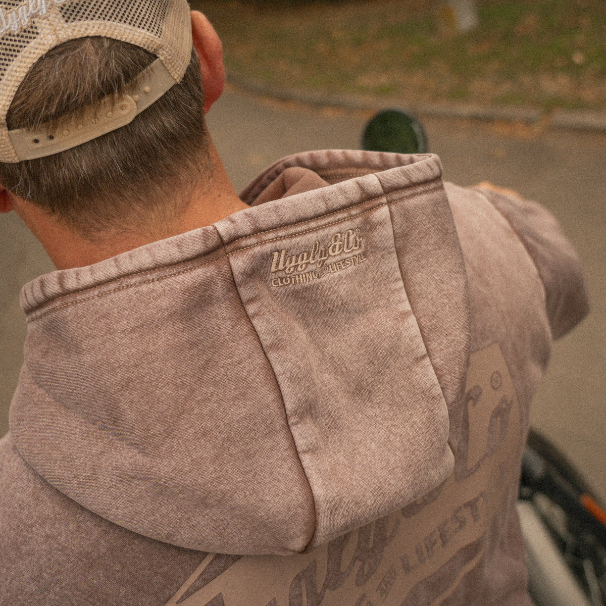 Close up of the Acid Wash Hoodie fabric and branding on hood