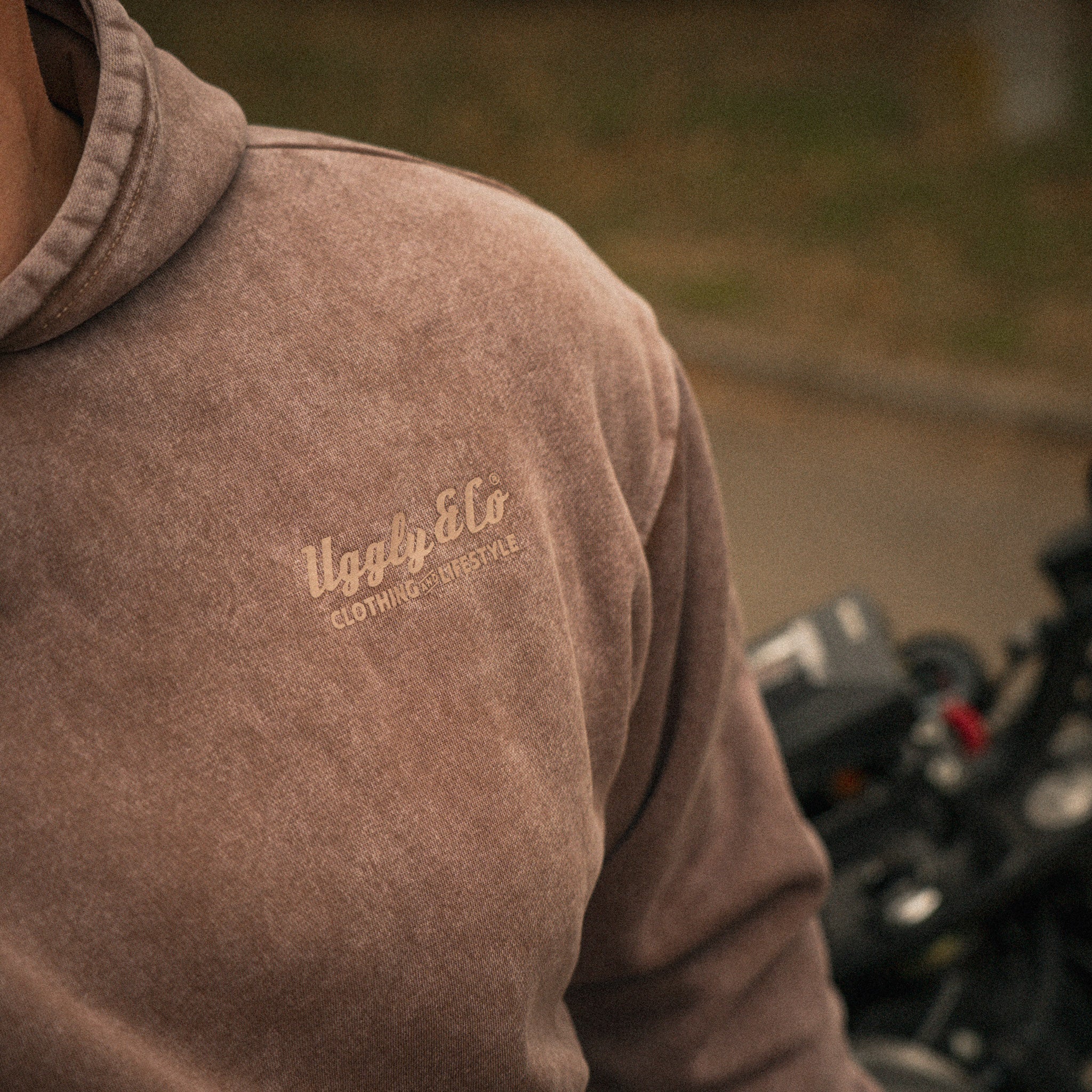Close up of the Clay Diamond Acid Wash Hoodie fabric and branding