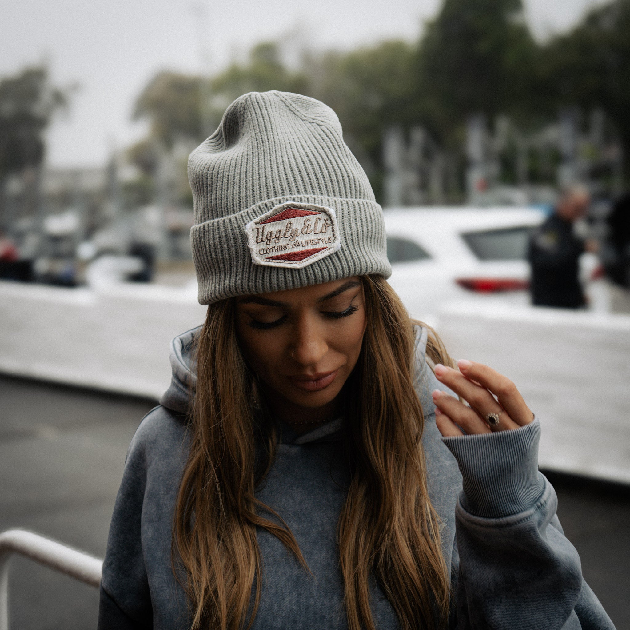 a close up shot of a girl wearing a blue acid wash vintage style hoodie