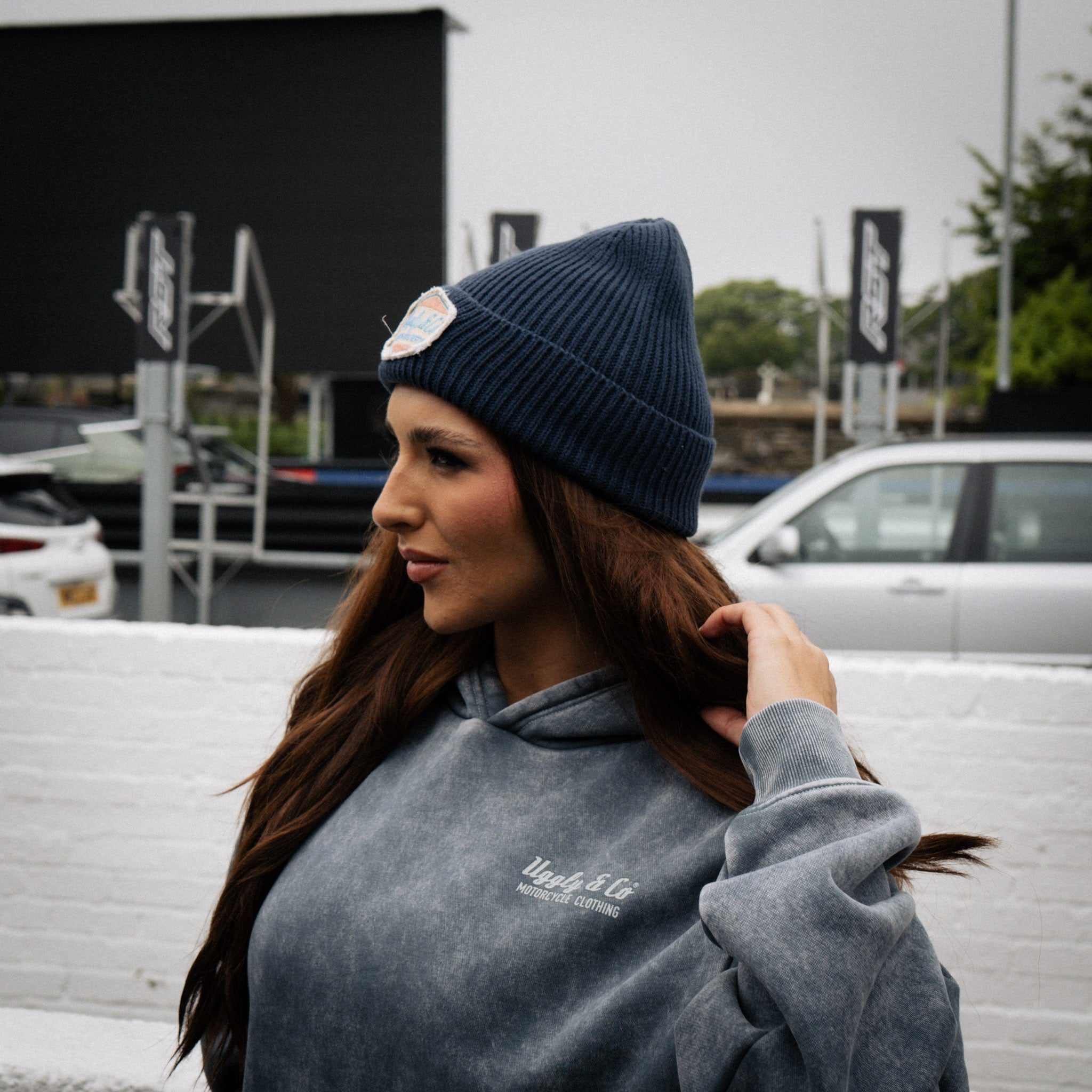 female model side view of blue beanie