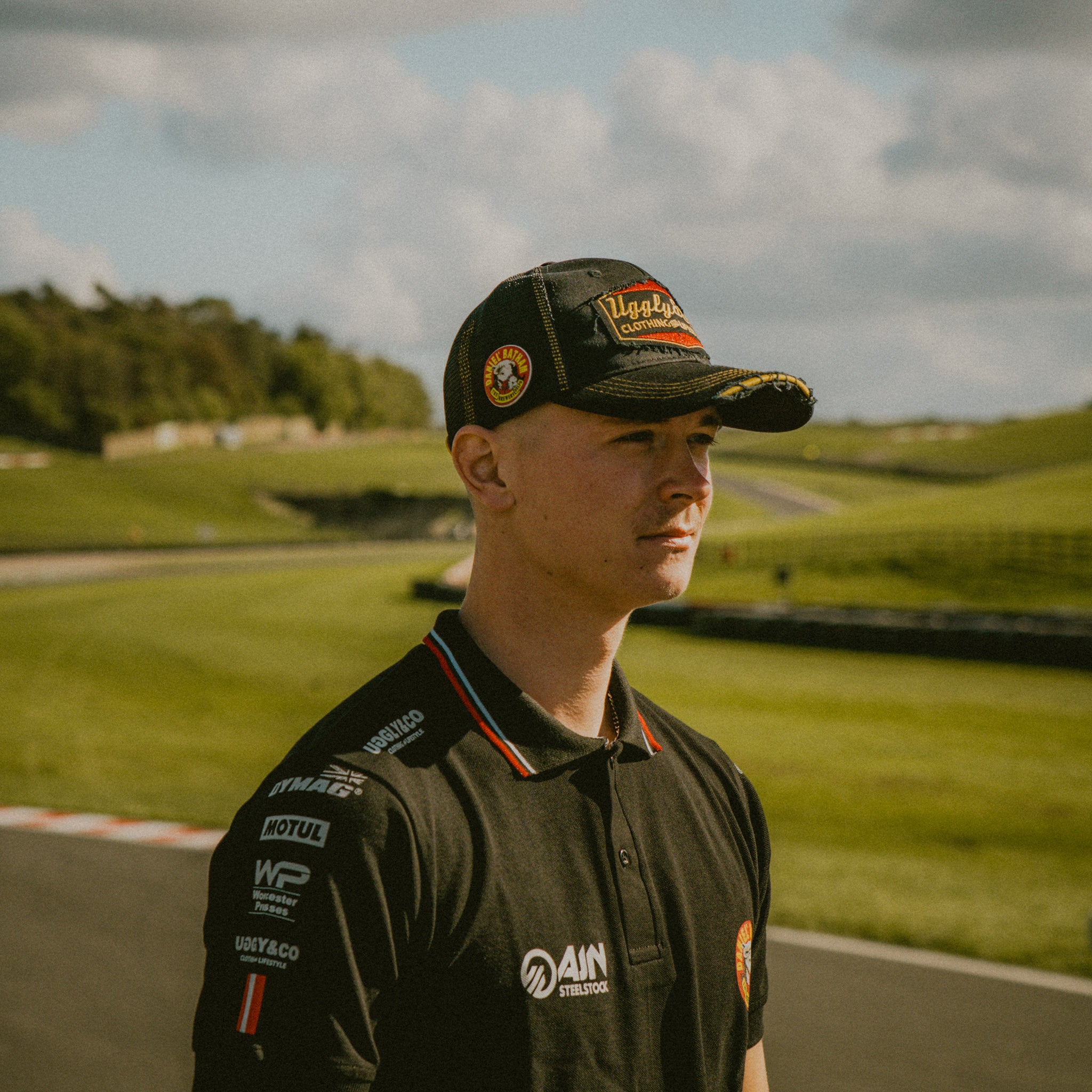 Side view of the Diamond Trucker Hat x Bathams Racing worn by storm stacey