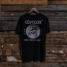 Rear view of a Carl Cox Motorsport BPM RPM black t-shirt on a wooden background