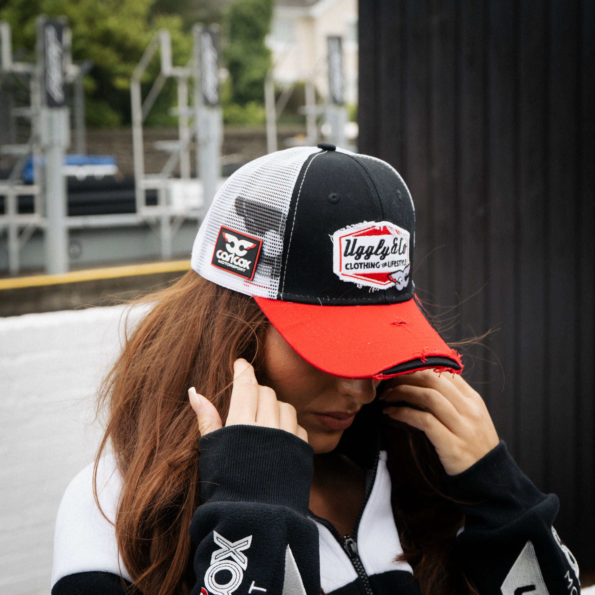 girl wearing matching carl cox trucker hat and track jacket
